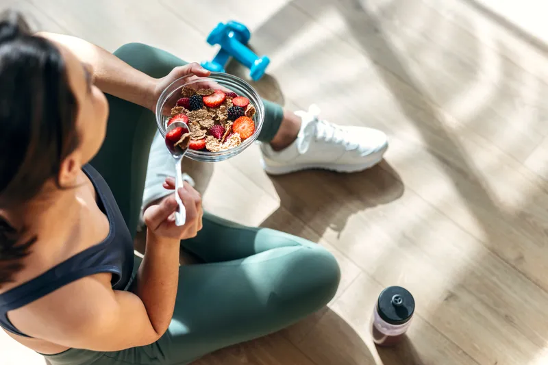 Woman eating a healthy meal in her kitchen