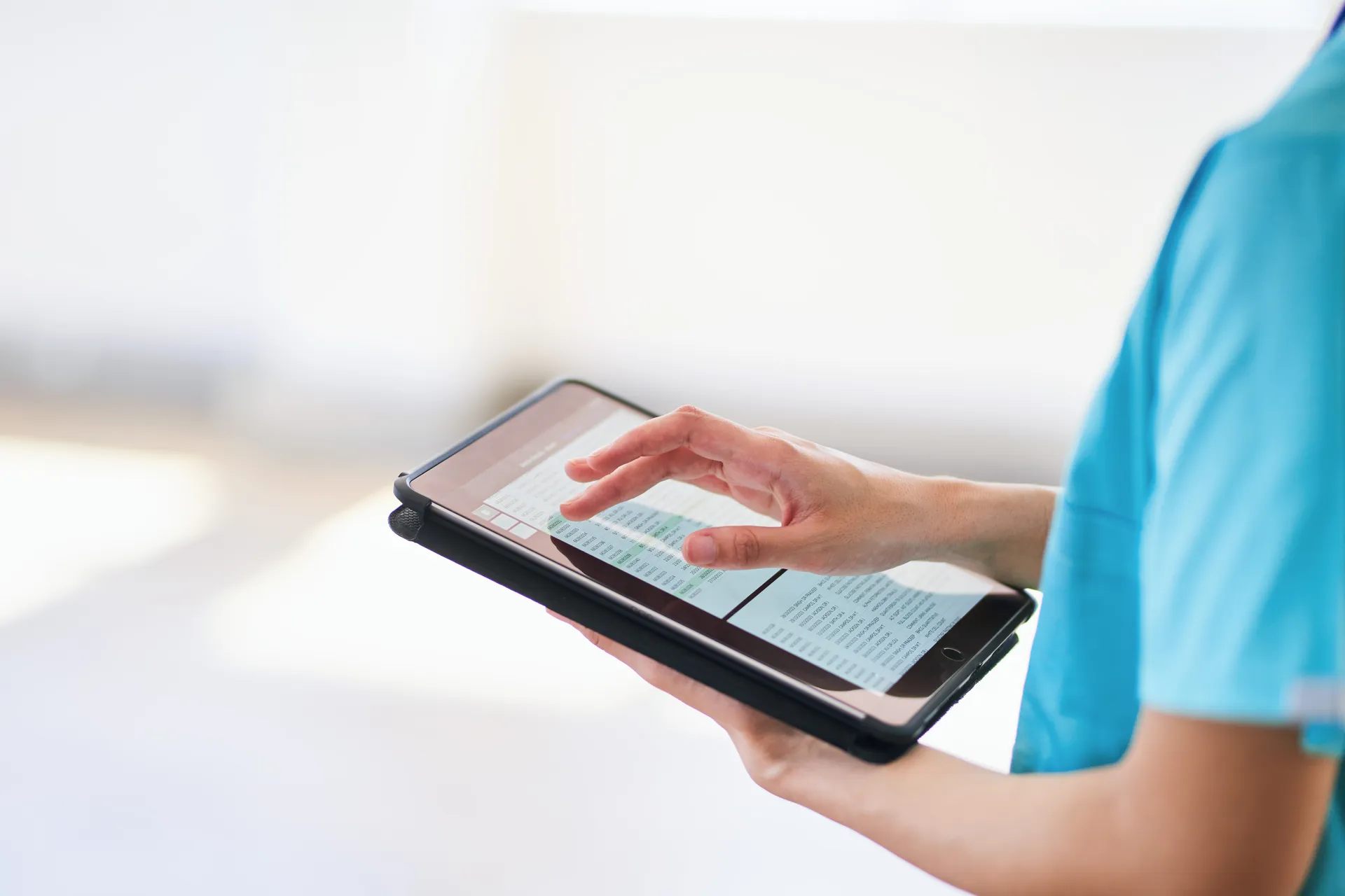 Medical professional using a tablet to access digital health records